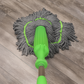 Green microfiber mop on a wooden floor