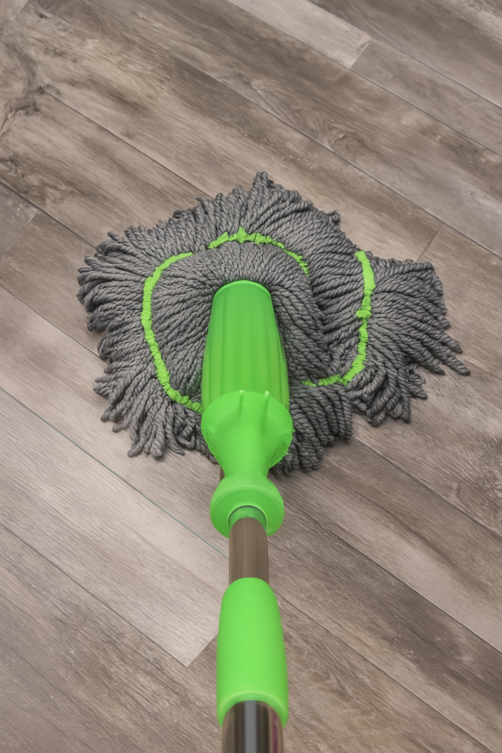 Green microfiber mop on a wooden floor